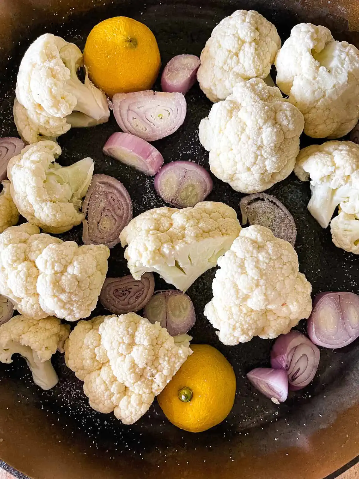 Picture of chicken skillet vegetables including cauliflower, shallot, and lemon. 