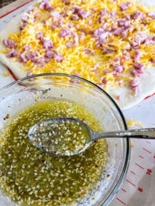 Butter and Everything but the bagel seasoning mixture for ham and cheese garlic knots