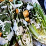 Close up of grilled caesar salad fully dressed.