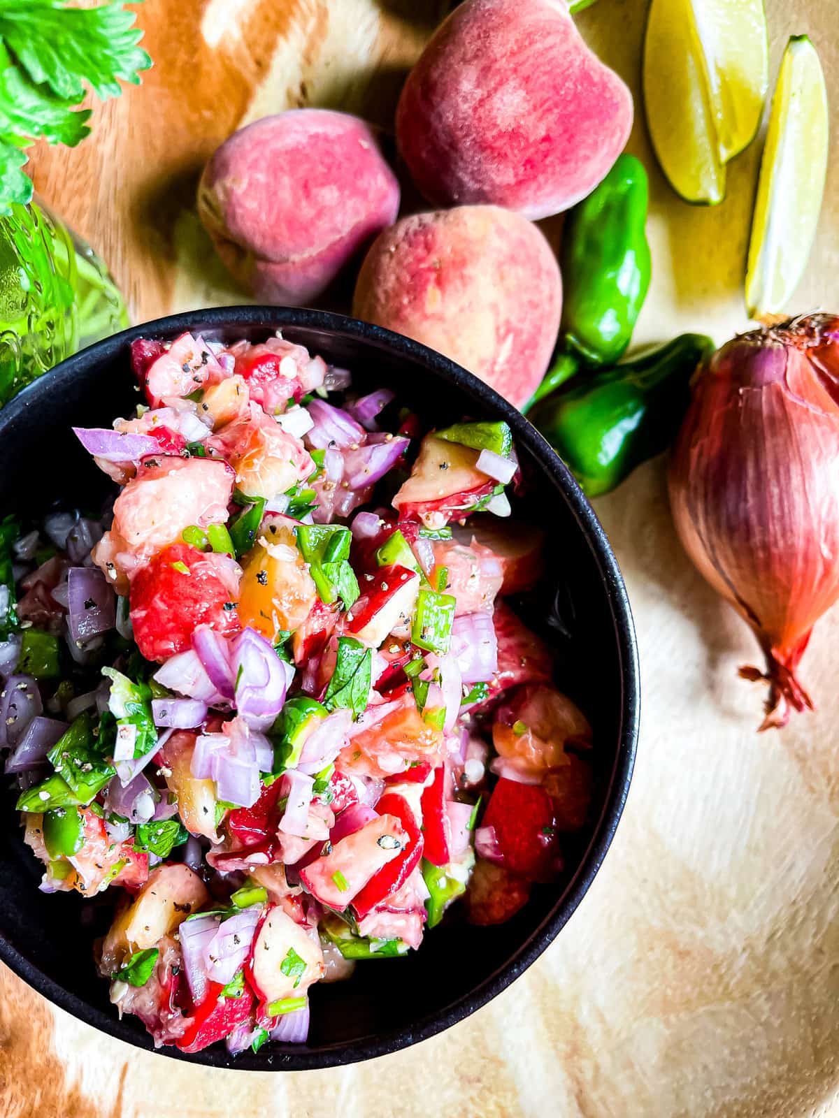 Close up of peach salsa and ingredients