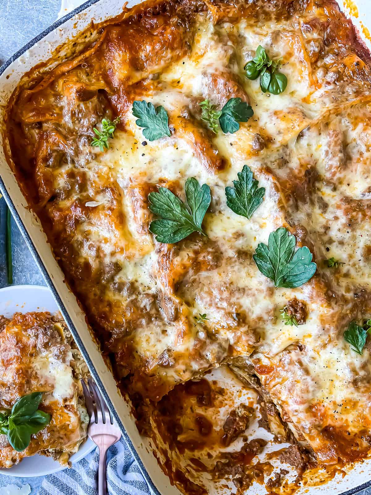 creamy pesto ricotta lasagna with fresh herb garnishes