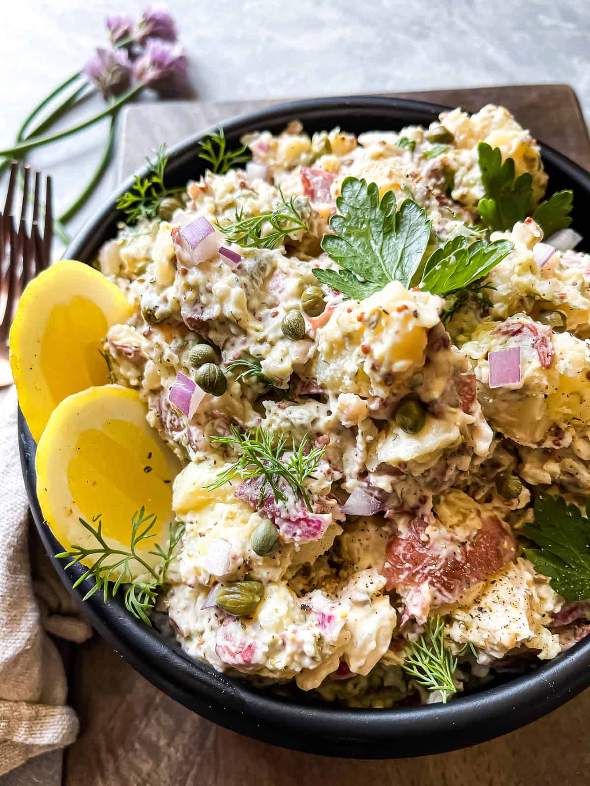 the best potato salad ever with dill, mayo, pickles, onions, and capers