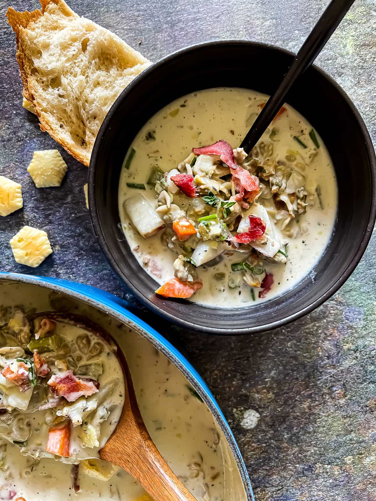 new england clam chowder in a dutch oven and bowl