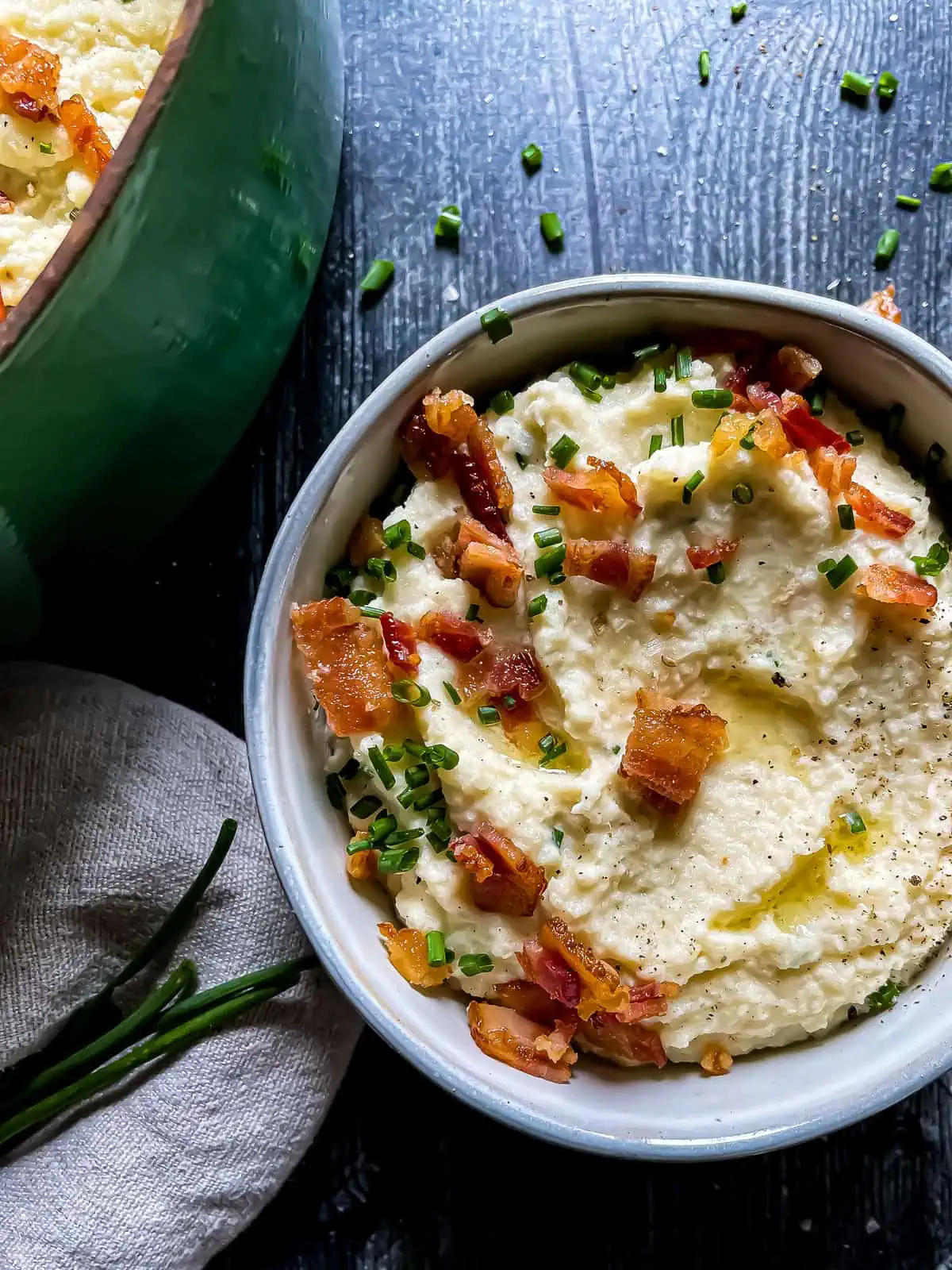 mashed cauliflower garnished with chives, bacon