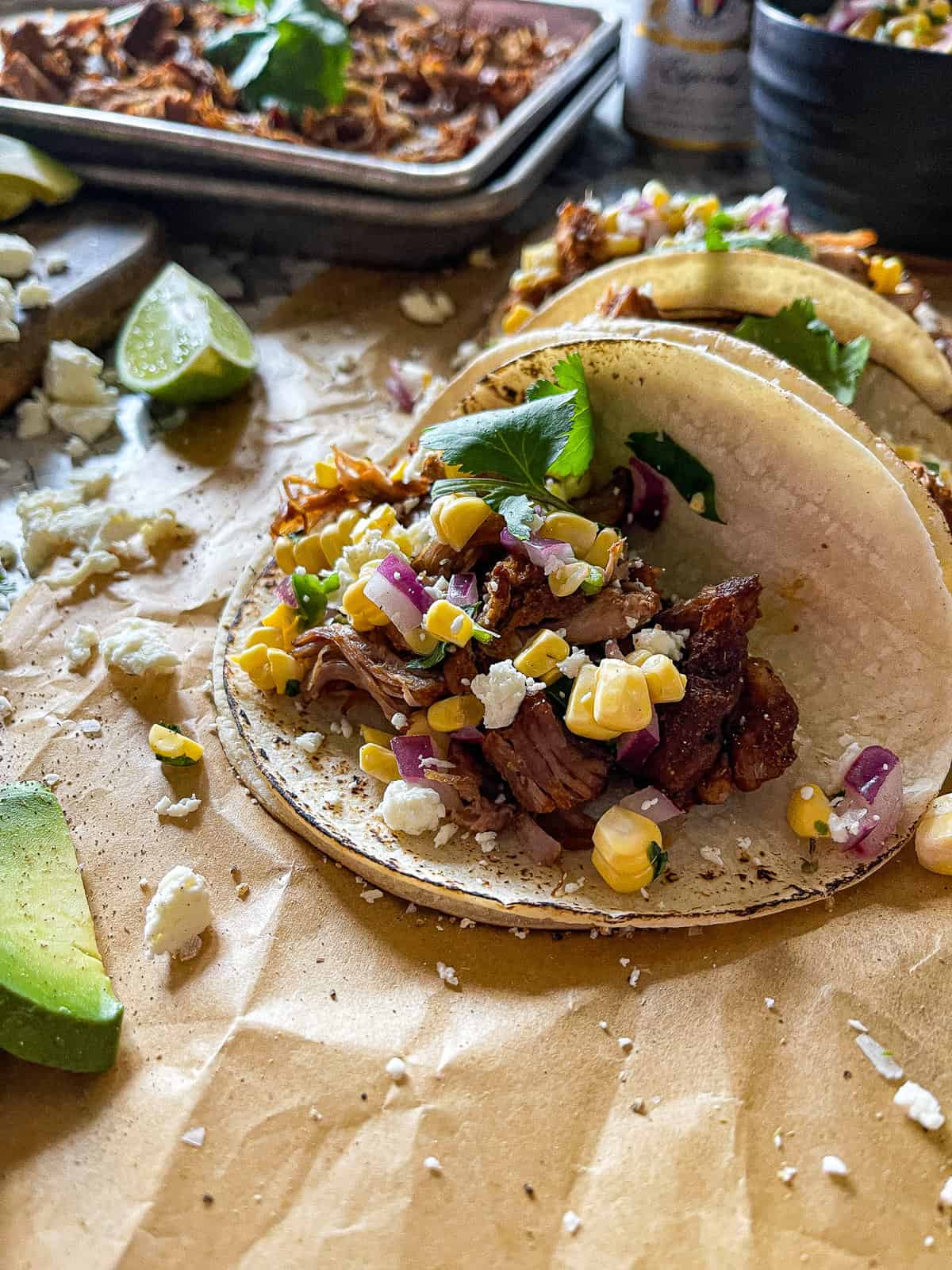 carnitas taco with sweet corn salsa and cilantro garnish