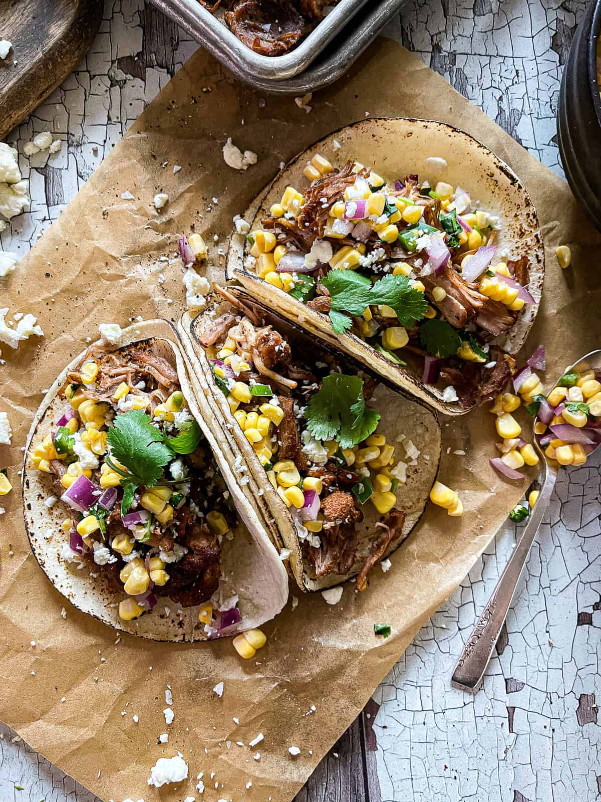 corn tortillas with carnitas, sweet corn salsa and cotija cheese