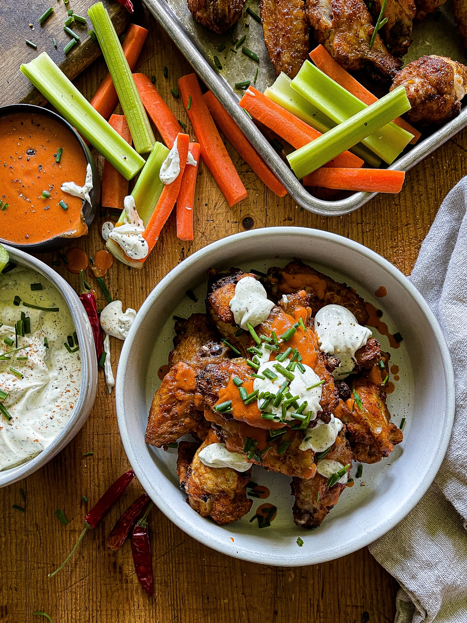 air fryer chicken wings with buffalo and ranch sauces, with carrots and celery sticks