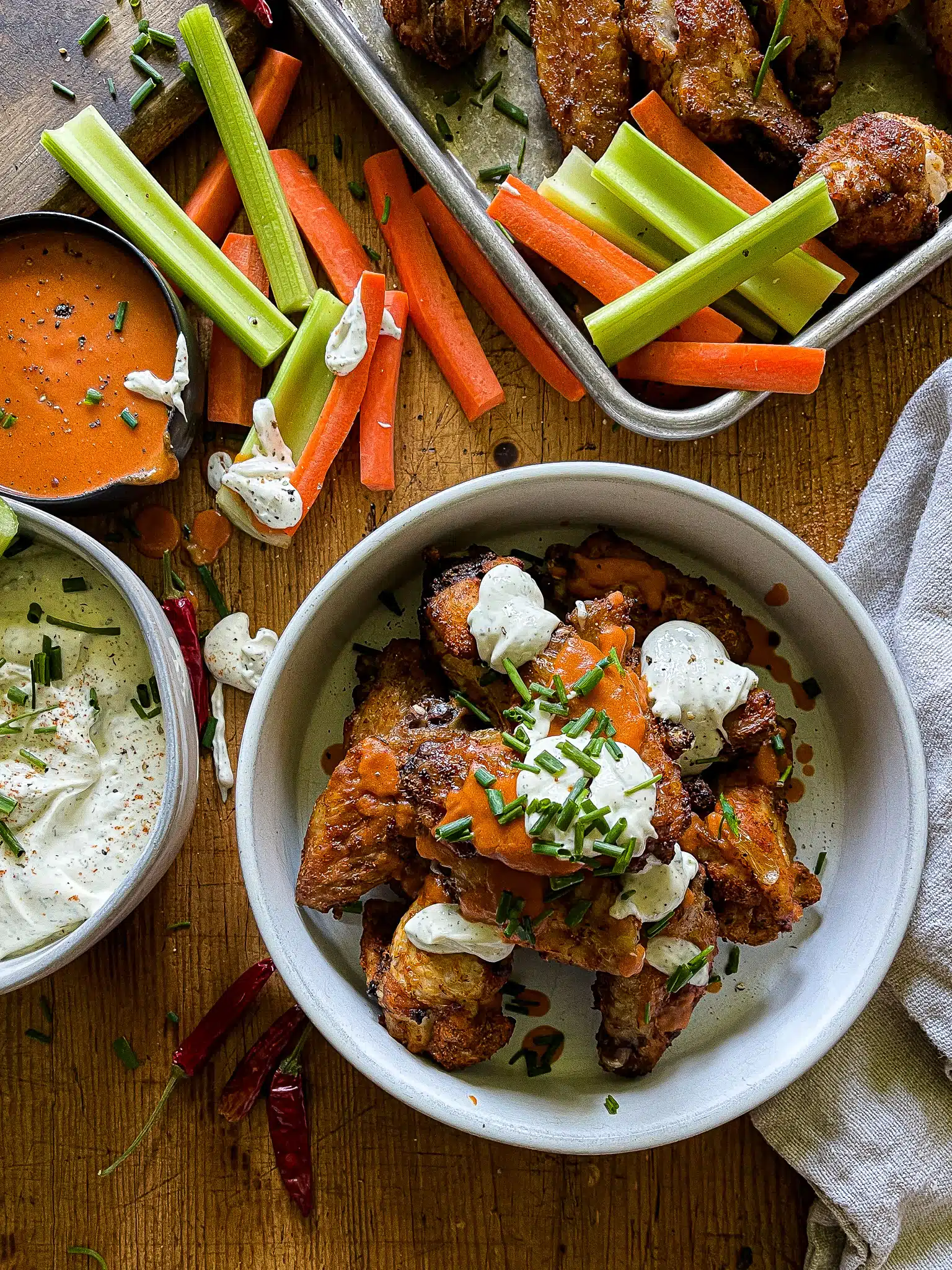 air fryer chicken wings with buffalo and ranch sauces, with carrots and celery sticks