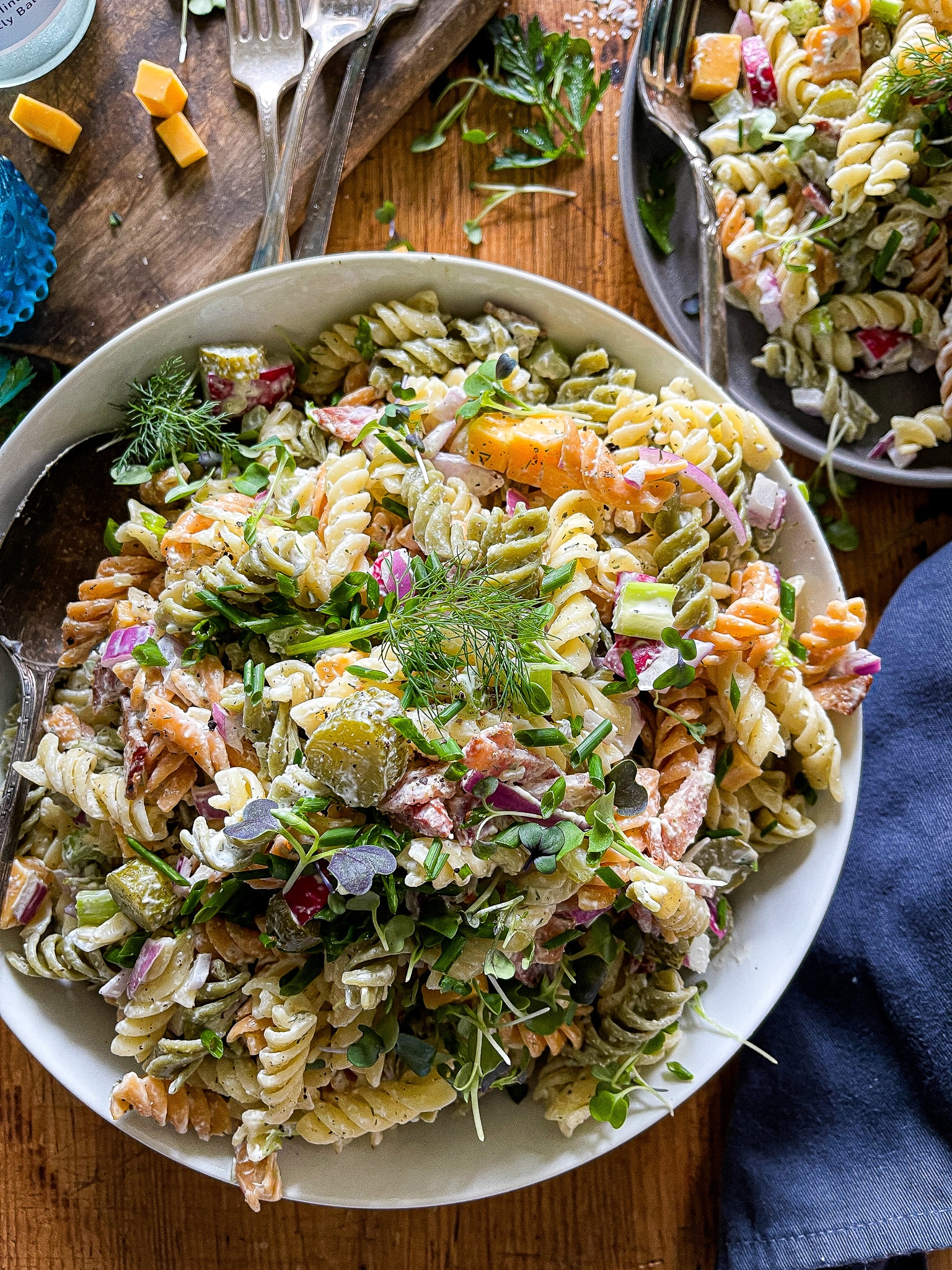 summer salad with pasta, pickles, cheese, dill dressing, radishes, celery