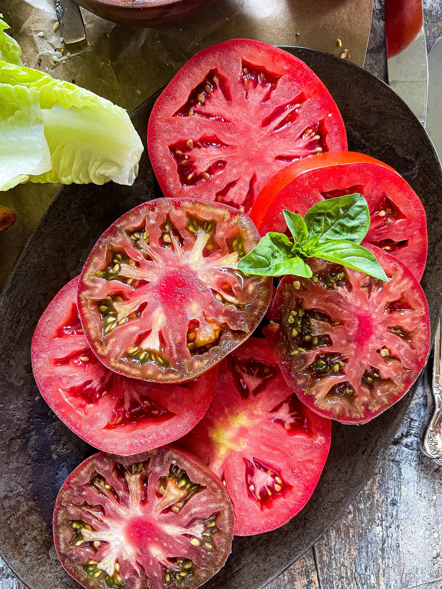 sliced tomatoes with a basil garnish