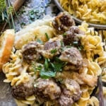 meatballs served over a bead of egg noodles