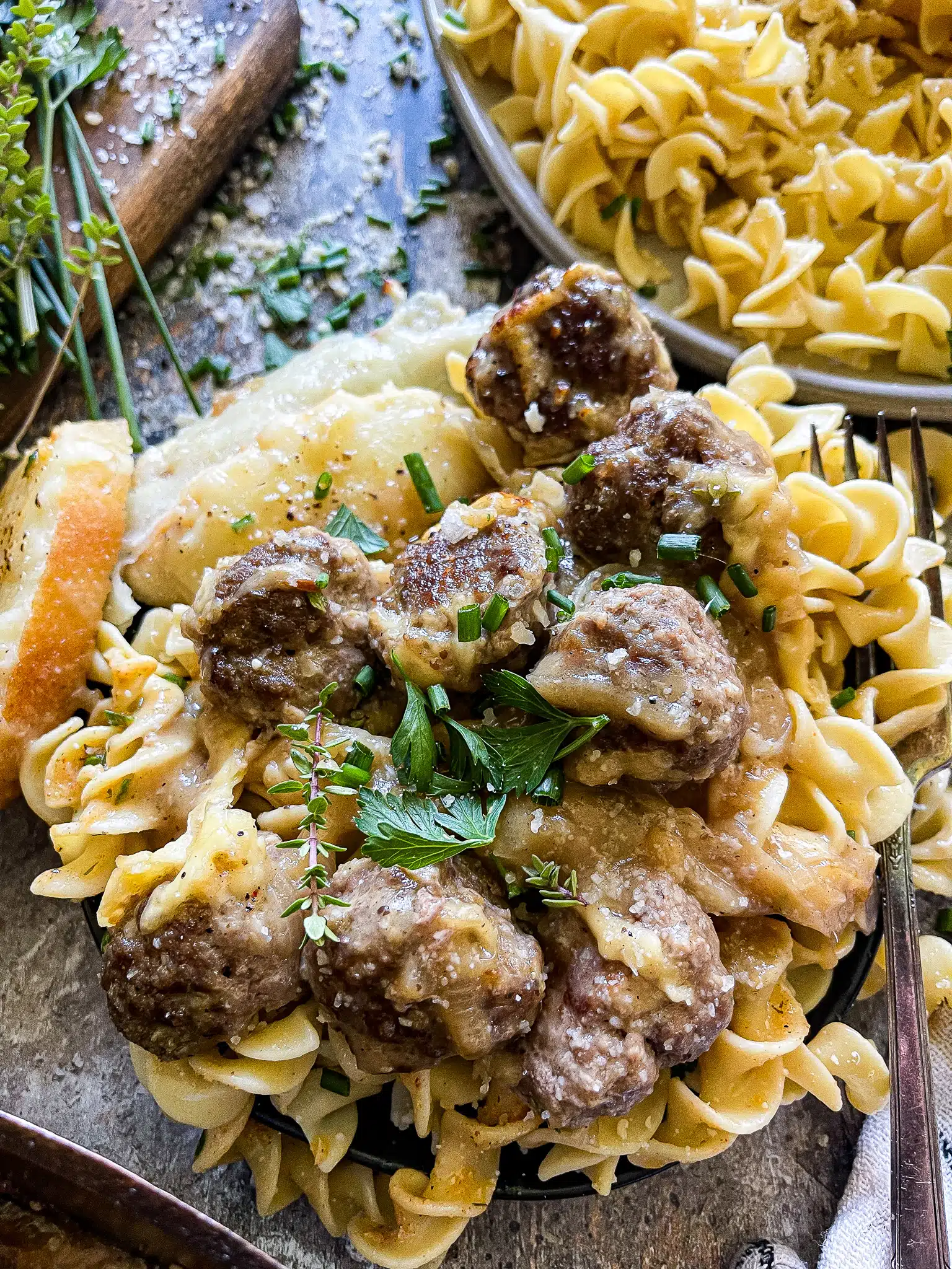 meatballs served over a bead of egg noodles