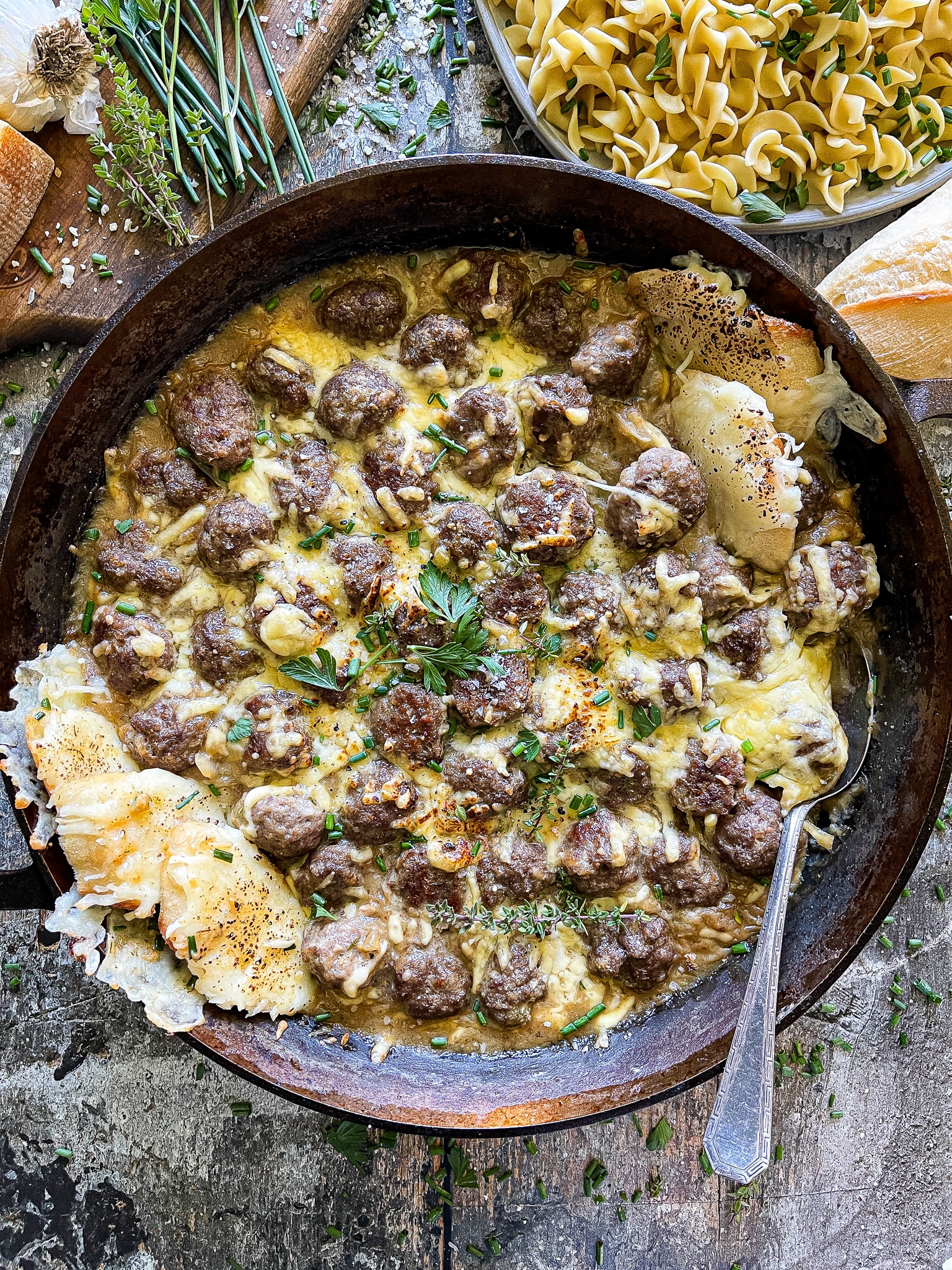 large cast iron skillet with french onion meatballs