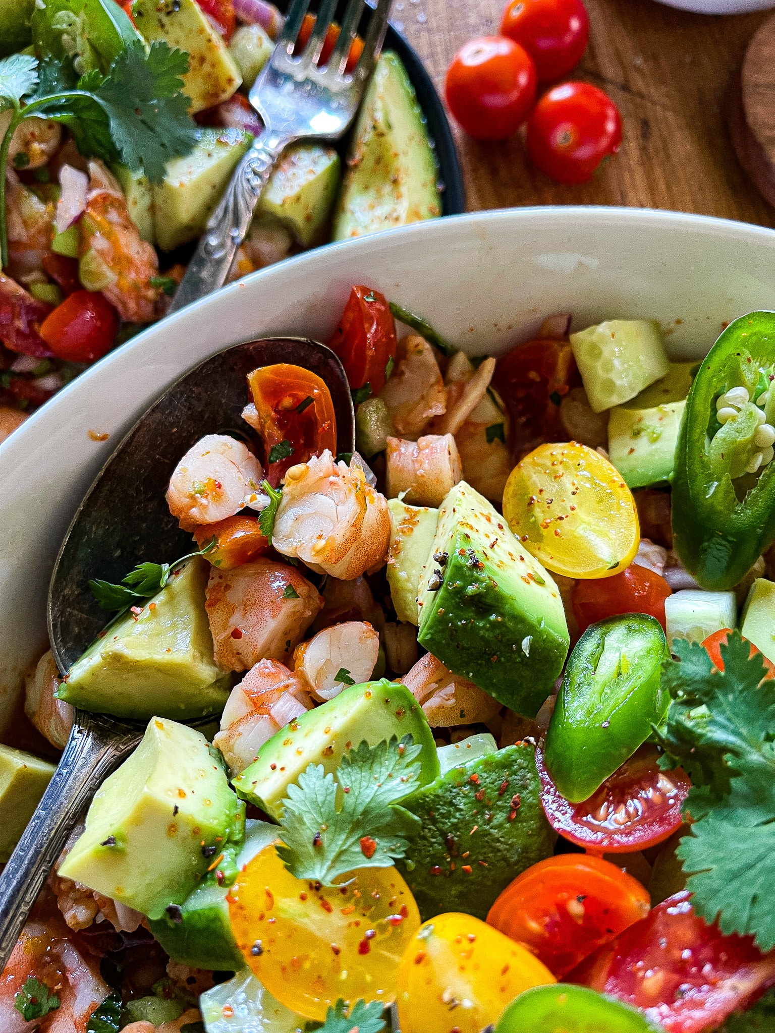 mexican shrimp ceviche in a bowl with avocado and cilantro garnishes