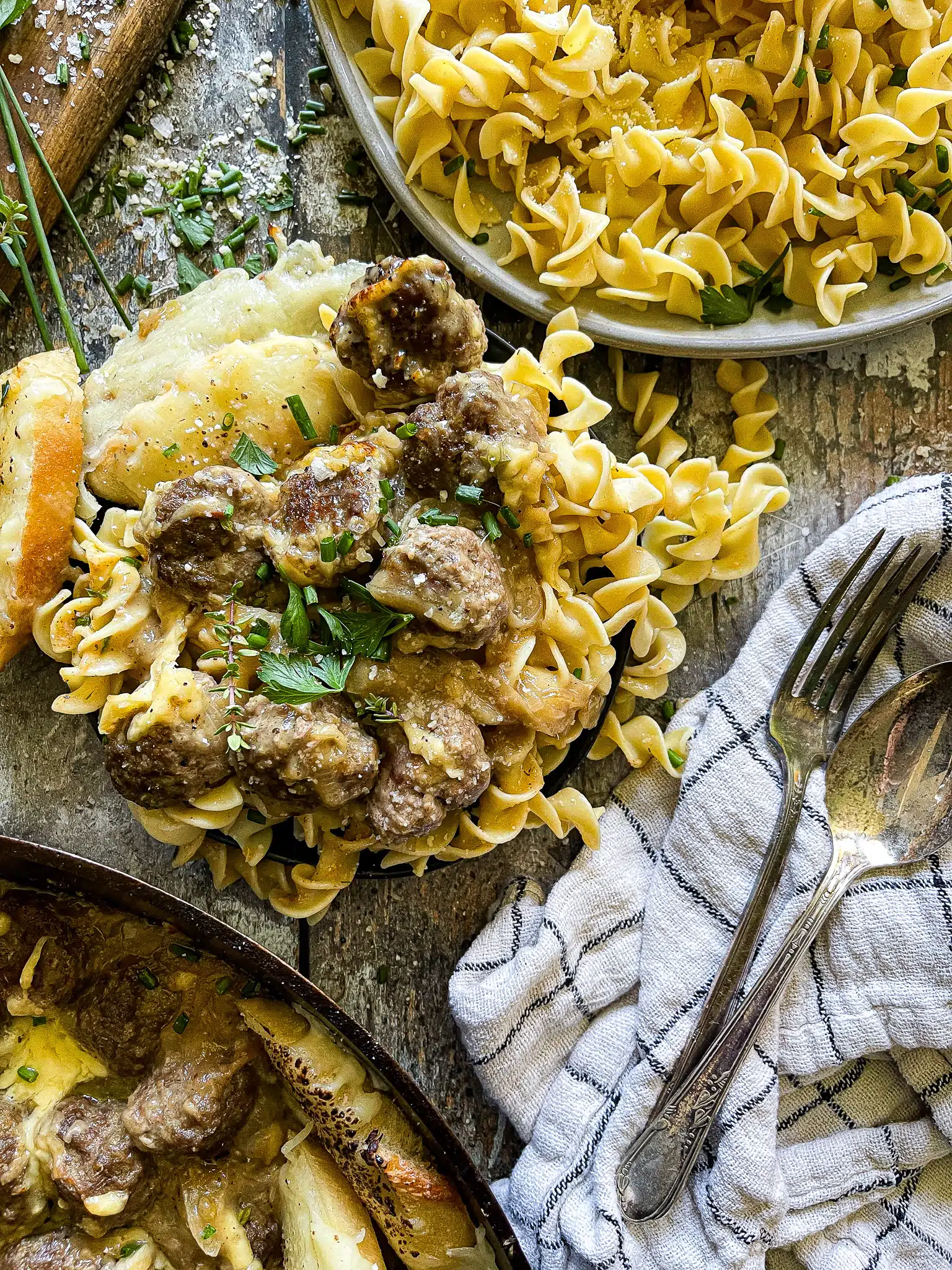 french onion meatballs served over buttered egg noodles