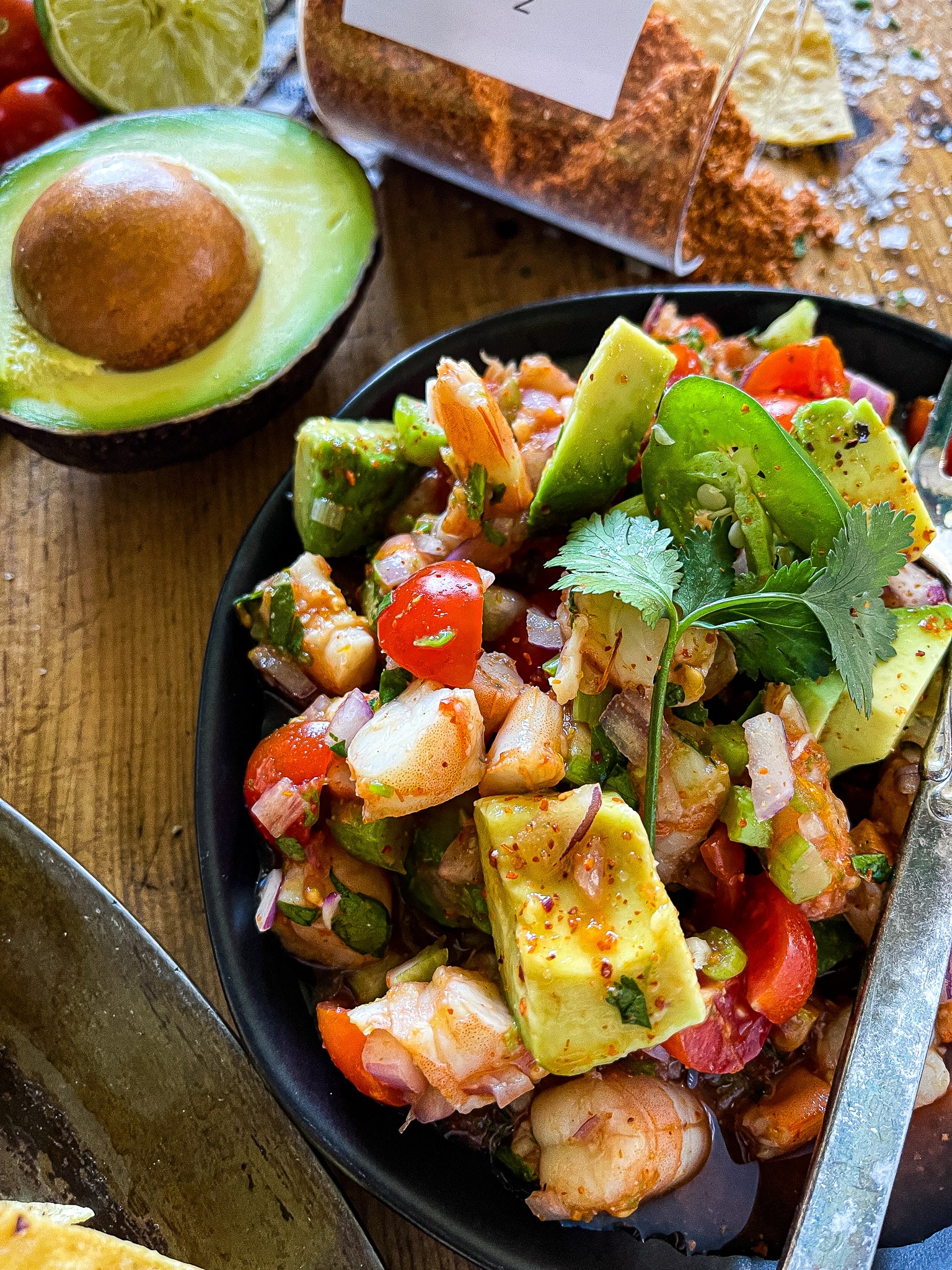 bowls of mexican shrimp ceviche with an avocado half