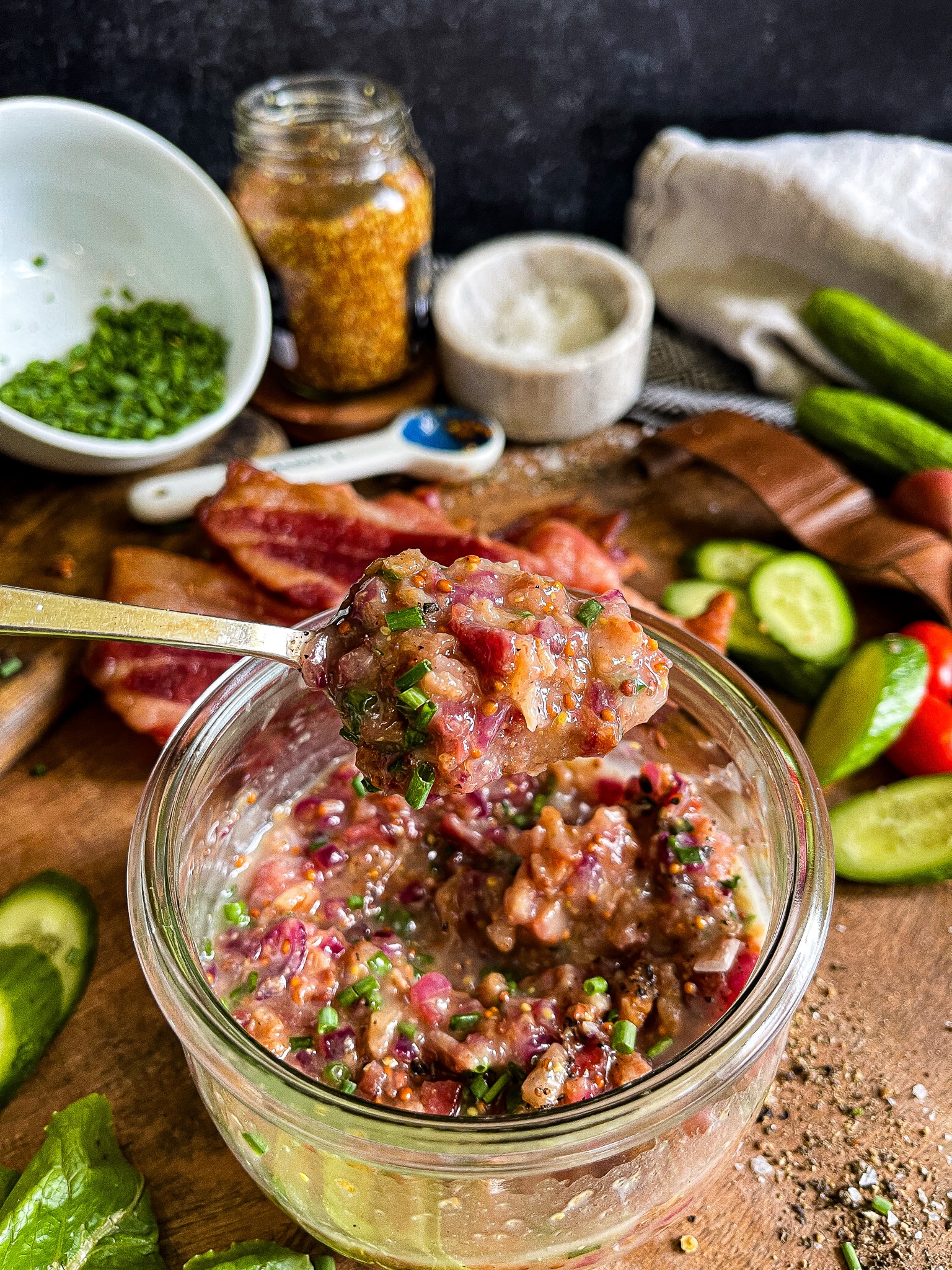 hot bacon dressing on a serving spoon