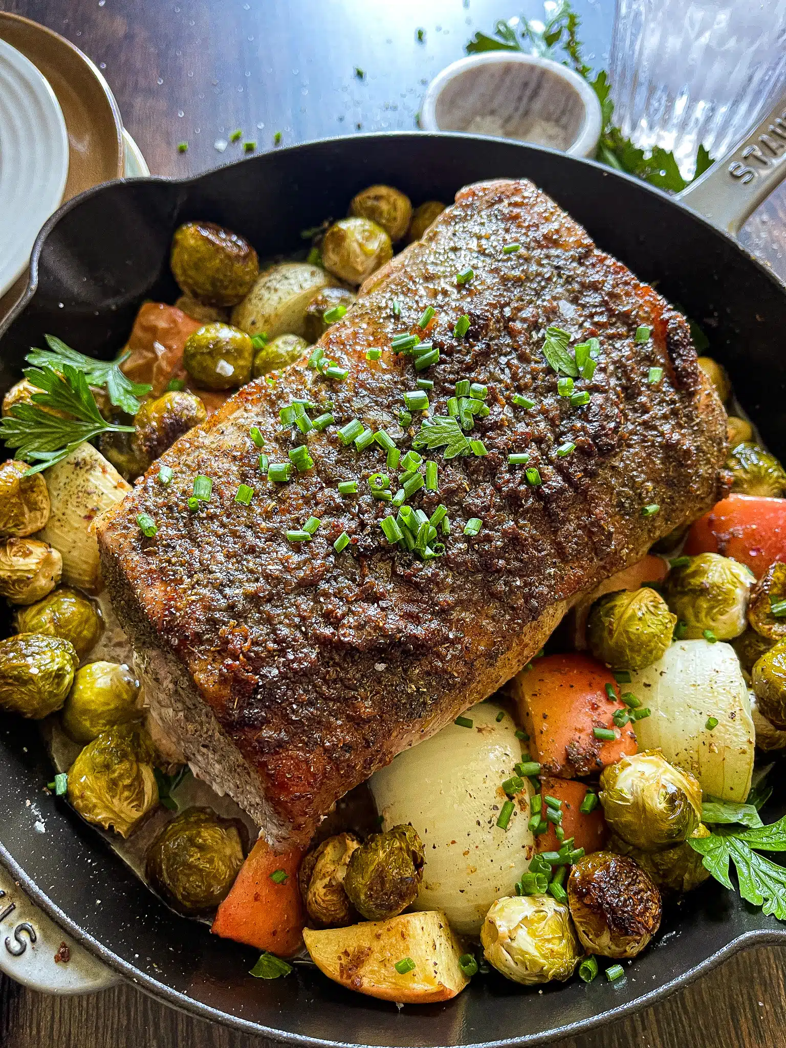 roasted pork loin on a bed of apples, onions, garlic, and brussels sprouts