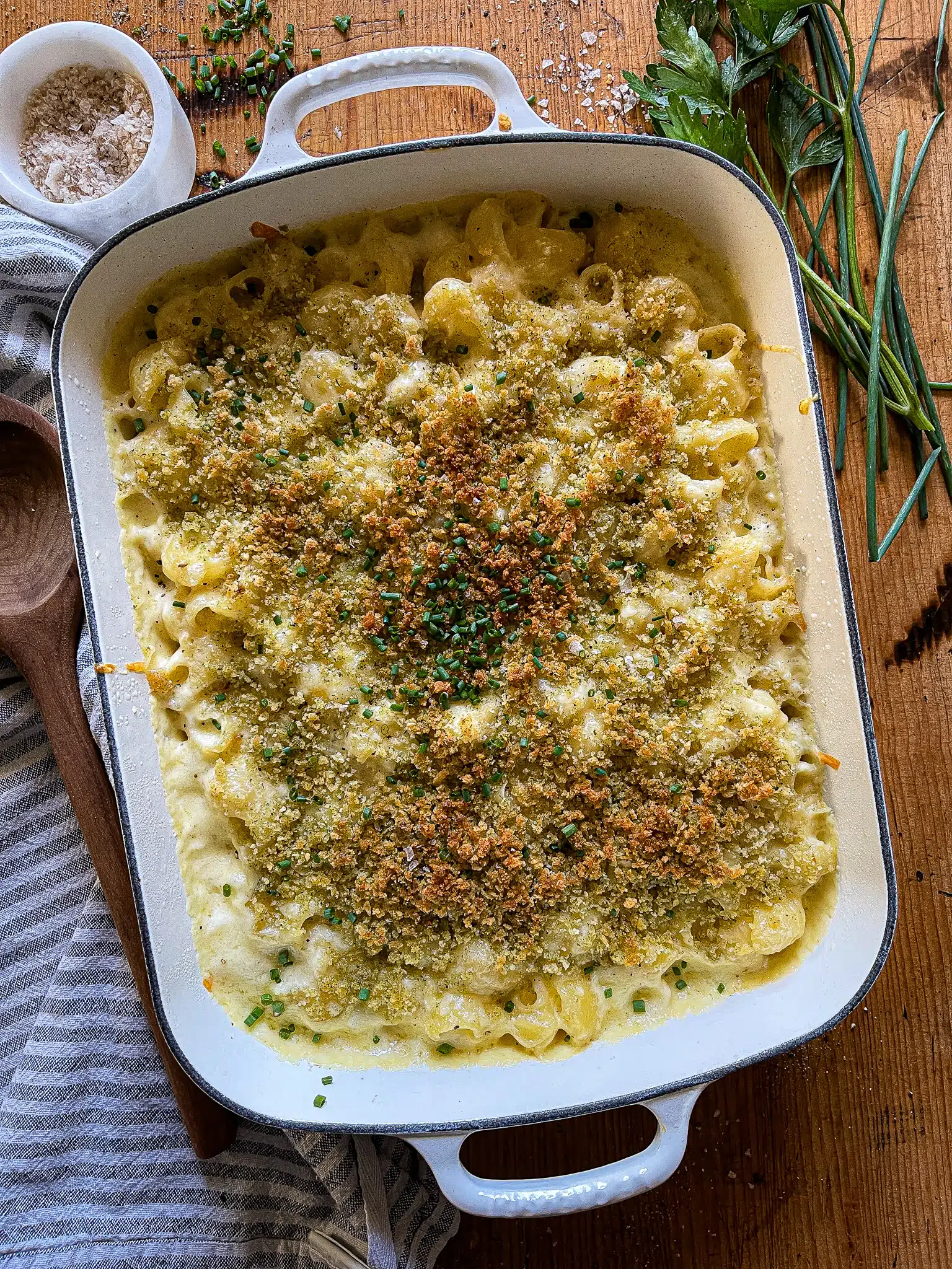 This is a picture of a white 9x13 baking dish with creamy baked mac and cheese with panko breadcrumb topping.