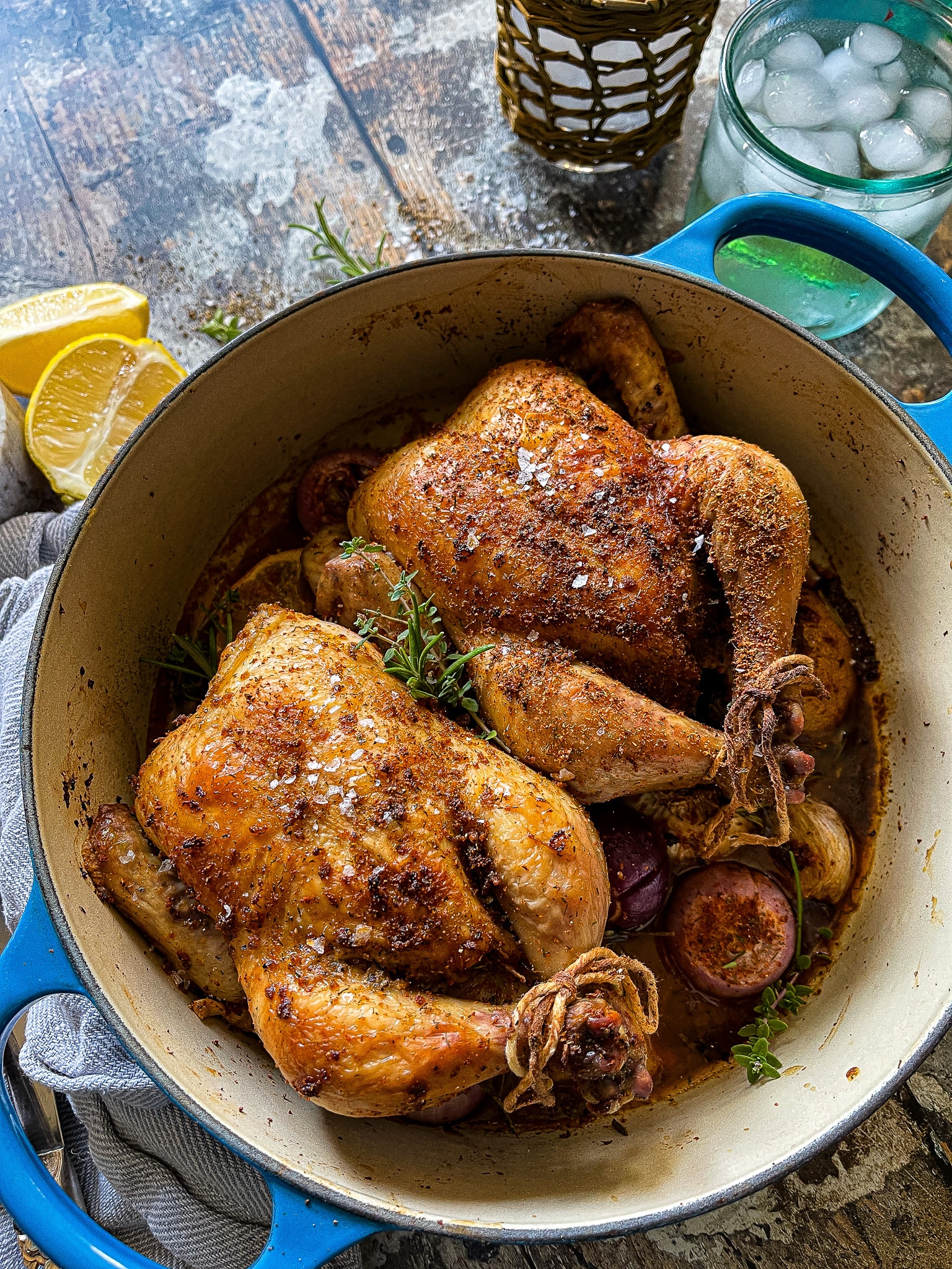 This is a picture of a small dutch oven with two roasted cornish hens.