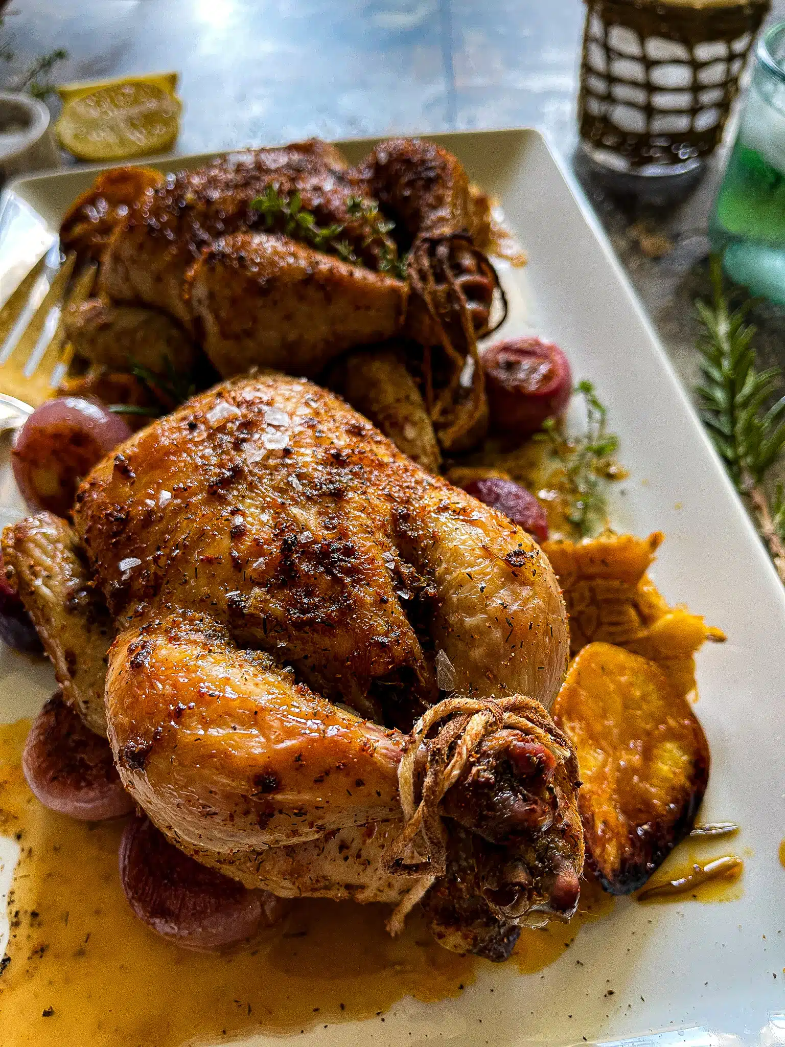 This is a serving platter with two roasted Cornish hens.