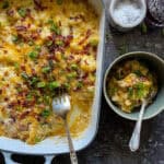 This is a picture of a baking dish with twice baked potato casserole and a small bowl with a portion of the casserole served in it.