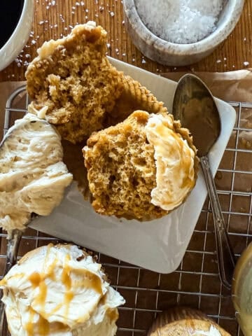 Fresh-baked banana bread with vanilla ice cream and caramel drizzle, served with coffee and salted caramel sauce on a wooden table, delicious dessert plate.