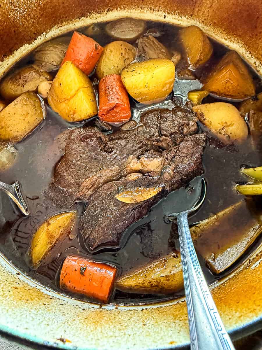 dutch oven pot roast with potatoes, carrots, and celery