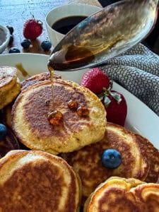 sausage pancakes drizzled with maple syrup
