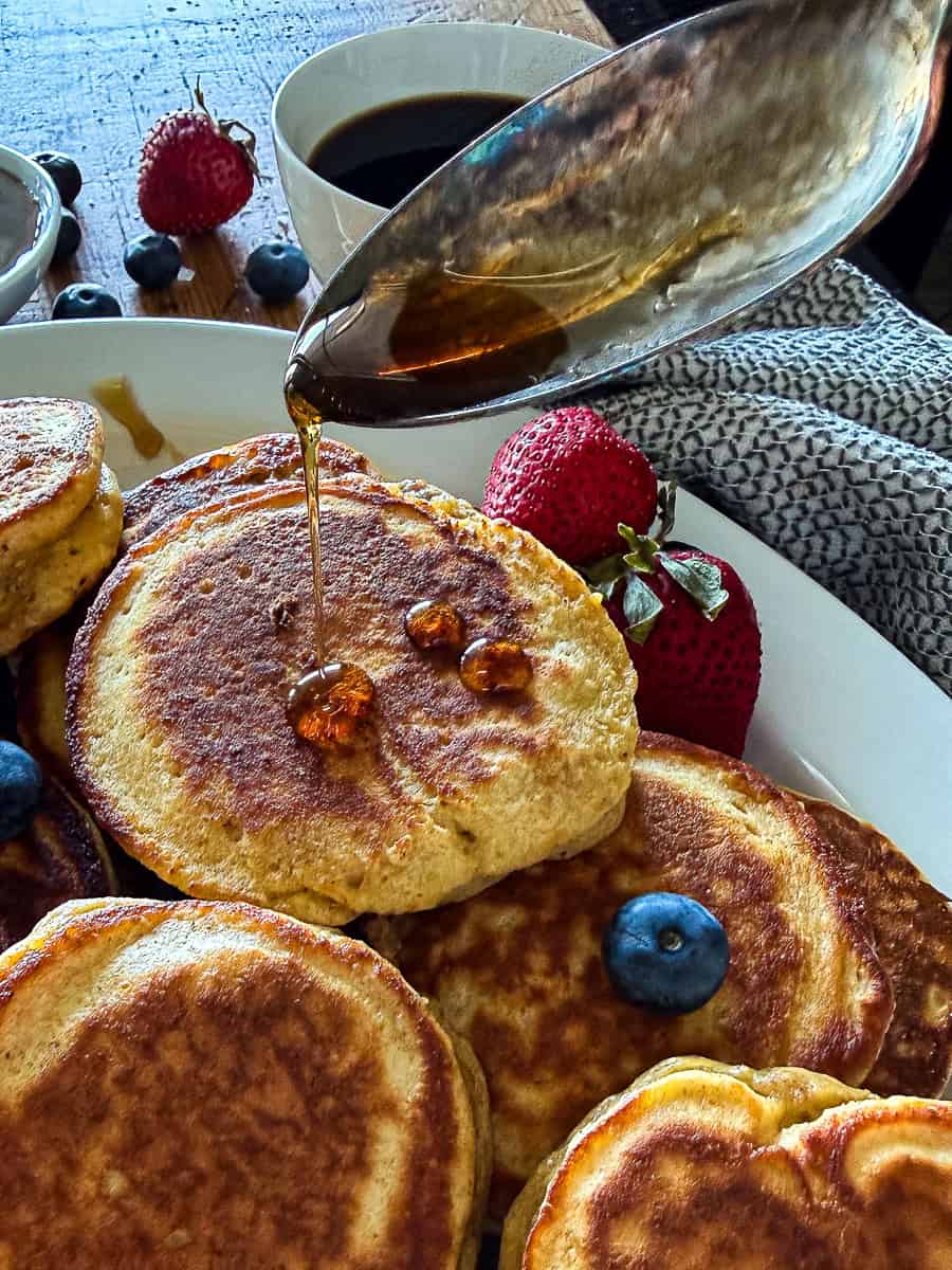 sausage pancakes drizzled with maple syrup