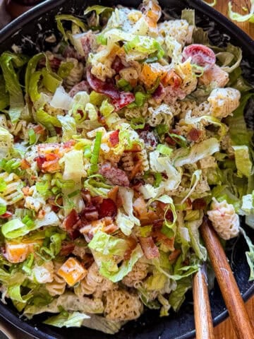 Bacon ranch pasta salad in a black bowl.