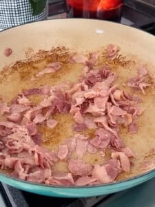 bacon cooking in a large skillet