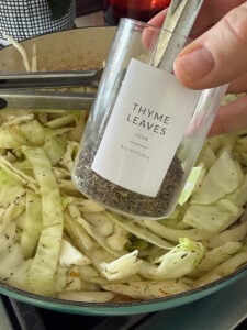 dried thyme leaves in a glass jar