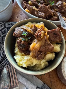 served slow cooker steak bites garnished with fresh time