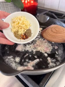 garlic, thyme, oregano, and chili flakes in a white prep dish