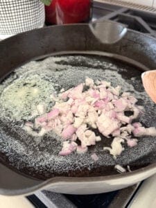 shallots cooking in butter in a cast iron skillet