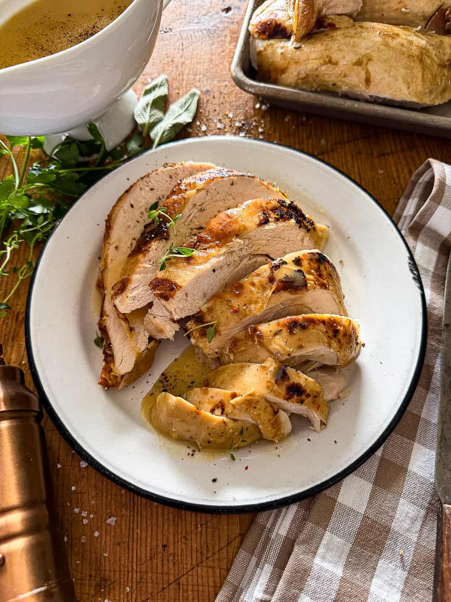 slow cooker turkey breast sliced and served on a white plate