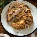 slow cooker turkey breast sliced and served on a white plate