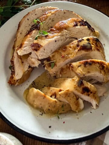 slow cooker turkey breast sliced and served on a white plate