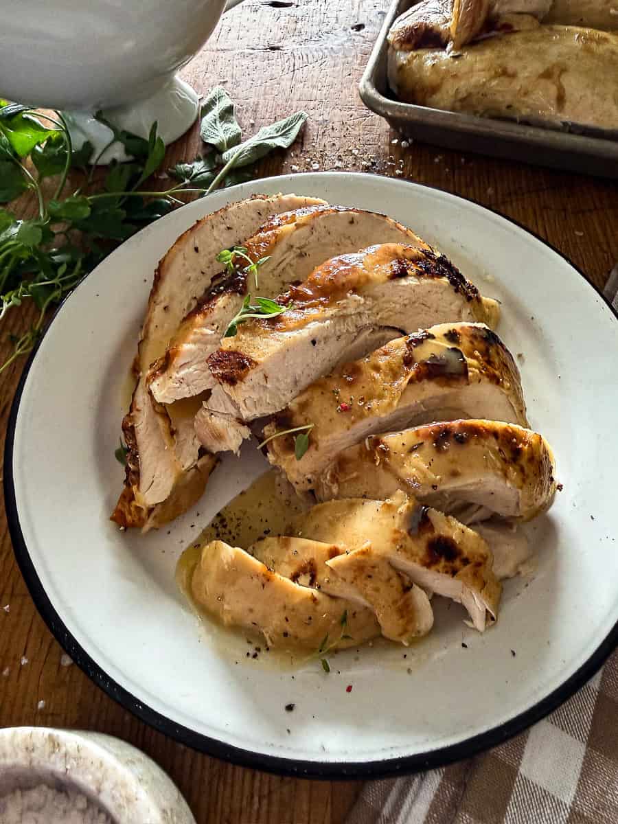 sliced and served turkey breast on a white plate